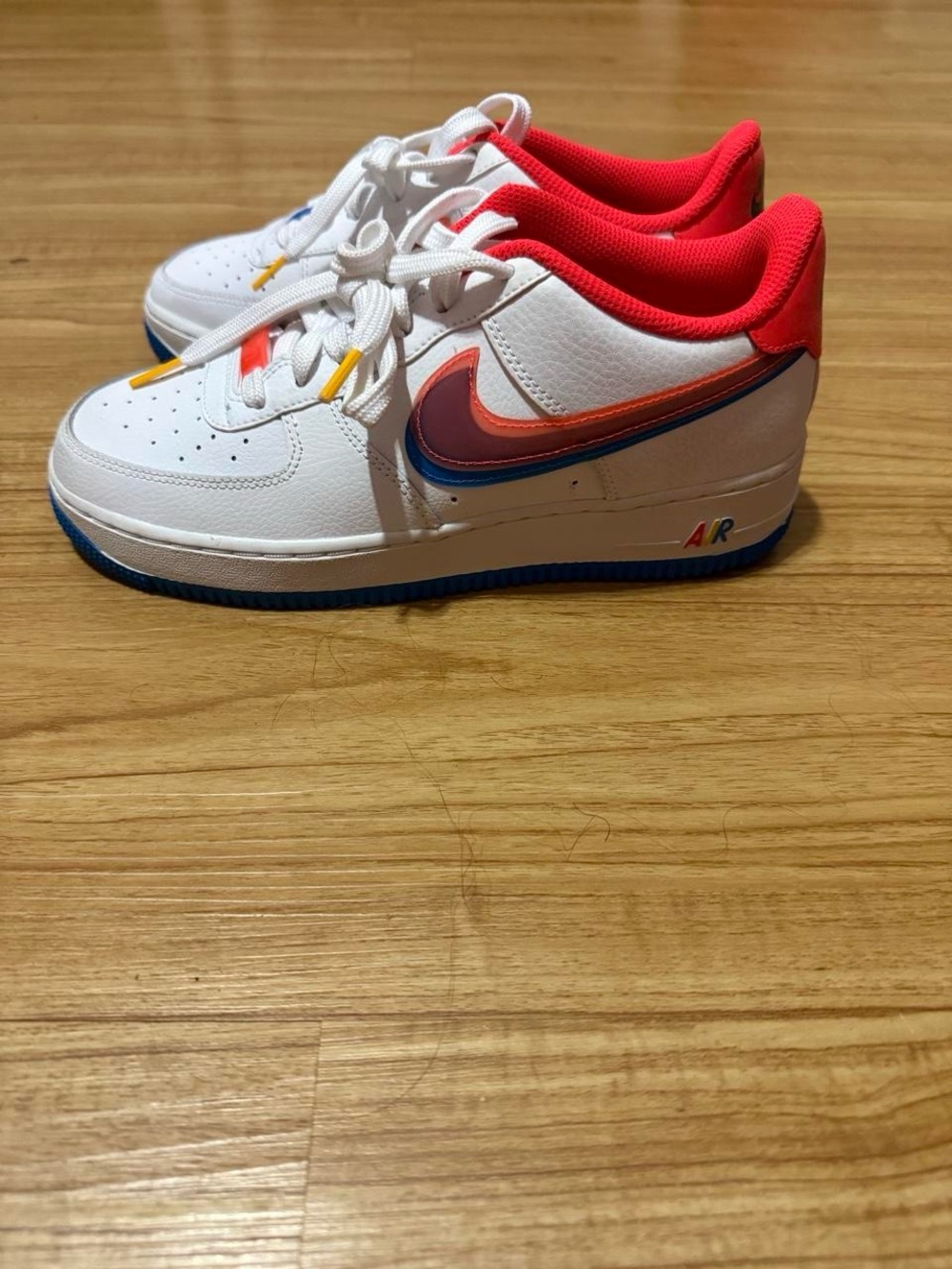 Nike Kids White Sneakers with Pink Lining and Blue & Orange Swoosh
